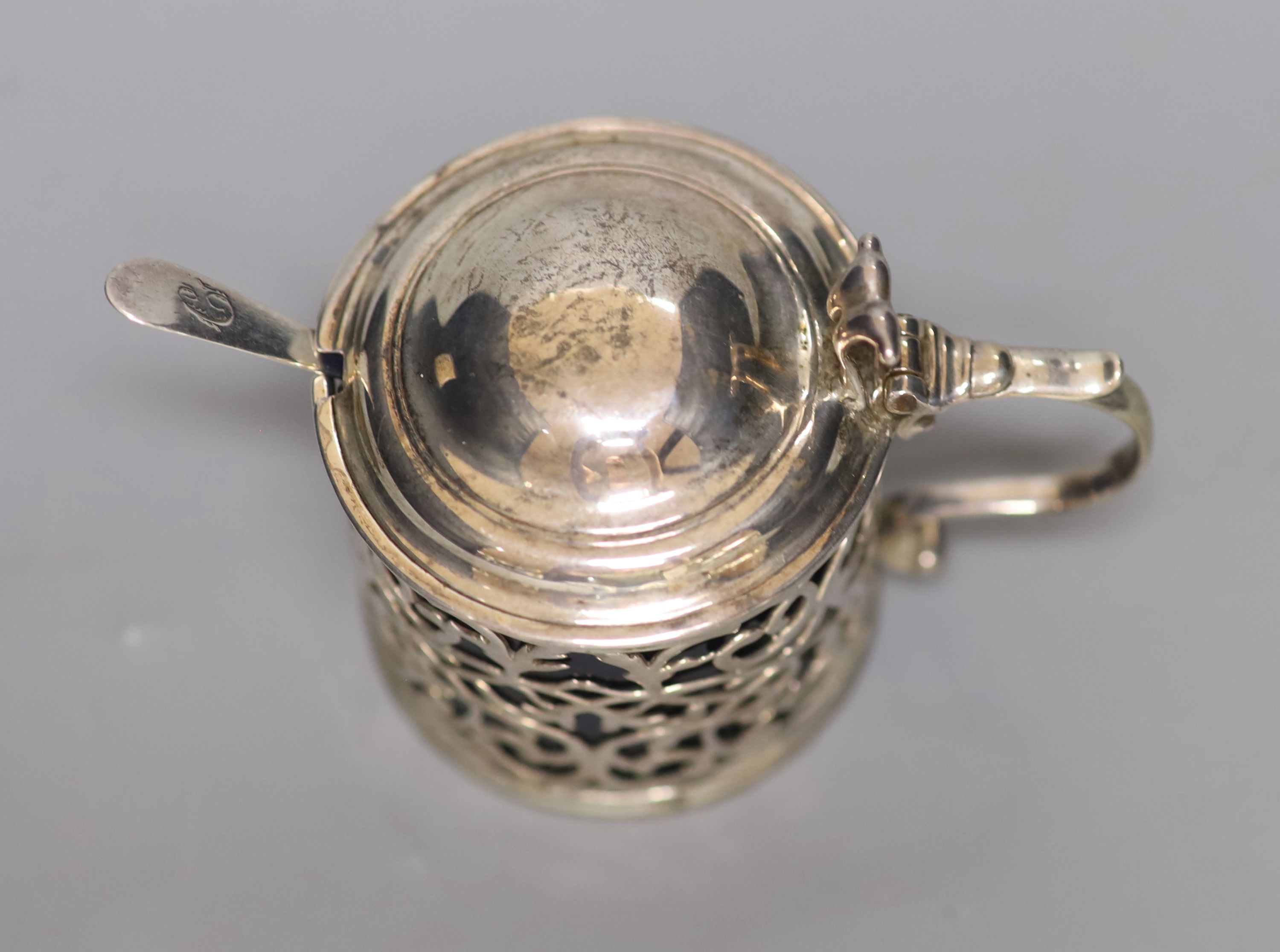 A George III pierced silver drum mustard, London, 1767, (a.f.) with blue glass liner
